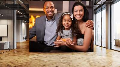 Portrait of beautiful mixed race family at home Wall mural