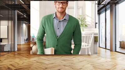 Portrait of handsome man with books Wall mural