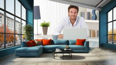 portrait of man at home with computer Wall mural