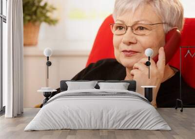 Portrait of senior lady on phone Wall mural