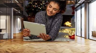 Woman shopping online at home in Christmas Wall mural