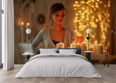 Woman with candles, fireplace, christmas lights. Wall mural