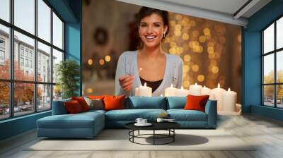 Woman with candles, fireplace, christmas lights. Wall mural