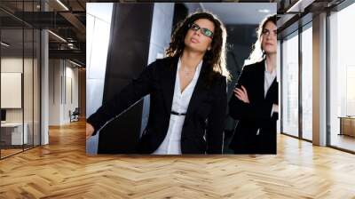 young businesswomen waiting for elevator at office corridor. Wall mural