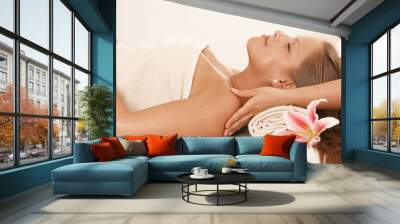 Young woman enjoying neck massage Wall mural