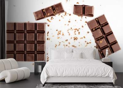 Pieces of dark chocolate bar, cubes, sprinkled with grated chocolate, isolated on white background, top view Wall mural