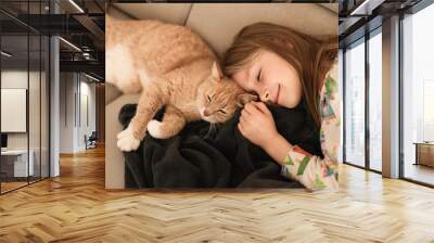 A girl near a ginger cat on the couch Wall mural