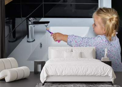 Little girl brushing teeth in the bath Wall mural