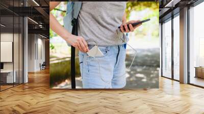 Female tourist connect smartphone to power bank Wall mural