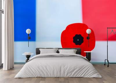 Calgary, Alberta, Canada. Nov 9, 2020. A remembrance day poppy flower with an French flag on the background. Wall mural