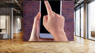 Smart phone camera privacy cover slide, for front camera cover for smart device hand hold on a red brick background Wall mural