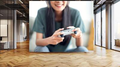 Closeup Hand of woman playing a computer games with joystick. Wall mural