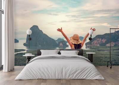 Freedom traveler woman relaxing with raised arms on the top of mountain at Thailand, Enjoy travel concept. Wall mural