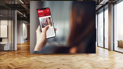 Online news on a smartphone. Mockup website. Woman reading news or articles in a mobile phone screen application at home. Newspaper and portal on internet. Wall mural