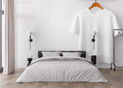 A simple white t-shirt hanging on a wooden hanger against a light wall, showcasing a minimalist and clean aesthetic. Wall mural