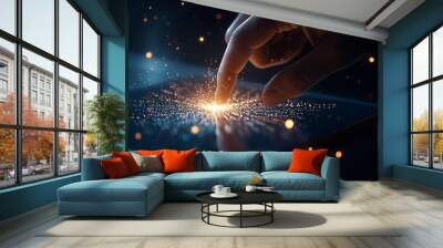 Hand touching a glowing interface with dynamic particles. Wall mural