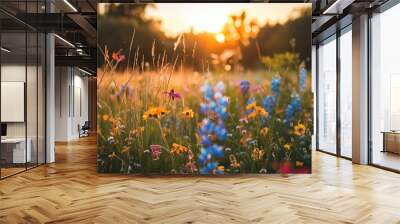 A meadow filled with flowers during sunset, with the flowers in the foreground captured in a realistic photo, backlit to emphasize their details Wall mural