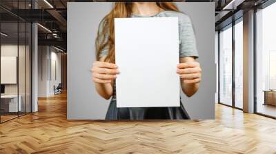 Woman showing blank white big A4 paper. Leaflet presentation. Pamphlet hold hands. Girl show clear offset paper. Sheet template. Booklet design sheet display read first person Wall mural