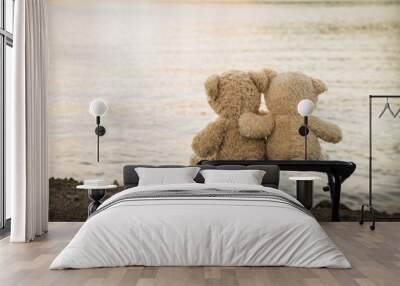 2 embracing teddybears sitting overlooking the lake and mountains Wall mural