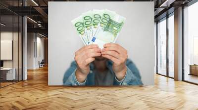 Businessman in blue shirt holds european euro money on white background, closeup. Money, earnings, crediting and finance. Wall mural