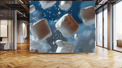 White marshmallows flying in the air with splashes on a blue background Wall mural