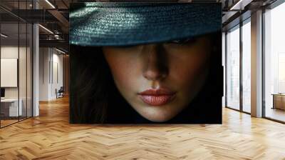 A close-up of an oversized hat casting a shadow over the face, with the brim creating a dramatic effect, Wall mural