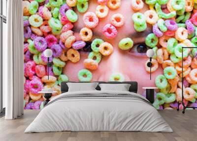 Rostro con expresiones de mujer joven sumergida en cereal de colores Wall mural