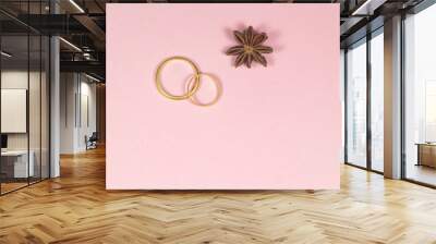 Two wedding rings and star anise Wall mural