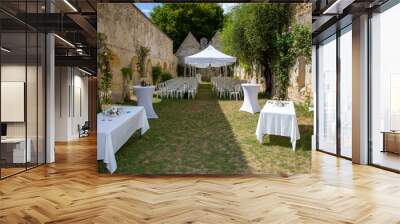 bride and groom place in summer wedding tent decorated for secular wedding ceremony garden Wall mural