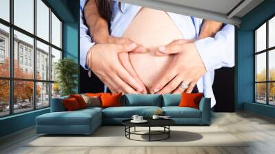 Close up of woman and man hands made heart on belly isolated on white background father mother health care love healthy pregnancy concept Wall mural