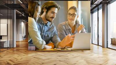 Colleagues team working business in modern co working space office Wall mural