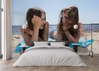 Complicity of two sisters on the beach Wall mural