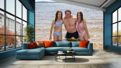 Father and his  two daughter on the beach Wall mural