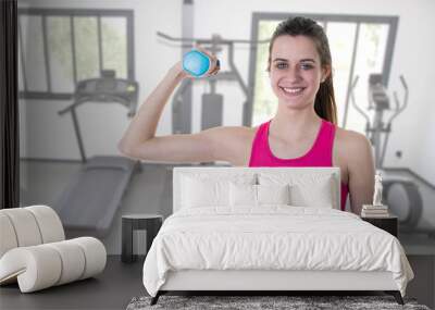 Fitness girl with blue dumbbell training exercise Wall mural