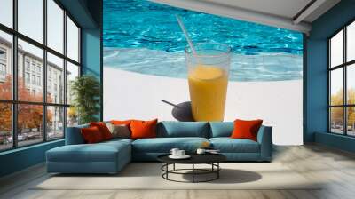 fruits cocktail at the edge of a resort pool. Concept of luxury vacation. Outdoor pool background Wall mural