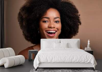 Happy African American woman portrait brunette smiling with afro hair curly in studio photo isolated brown background Wall mural