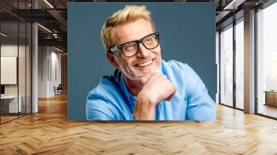 man handsome bearded middle aged guy with trendy eyeglasses smiling in grey background Wall mural