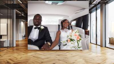 Newlywed african couple sitting in the car Wall mural