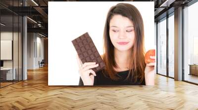 portrait of young pretty woman cute with apple and chocolate bar temptation Wall mural