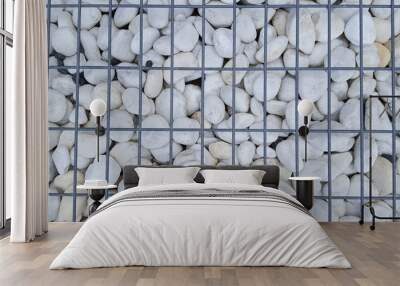 Stabbed gray stones behind a metal lattice Stone background Wall mural