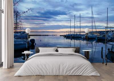 sunrise or sunset on blue water marina boats in lake of biscarrosse landes france Wall mural