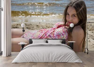 Teenager, girl in pink swimming suit on the beach Wall mural