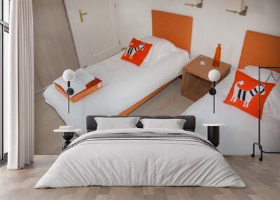 Two beds bedroom with bedside table and lamp, orange and white color Wall mural