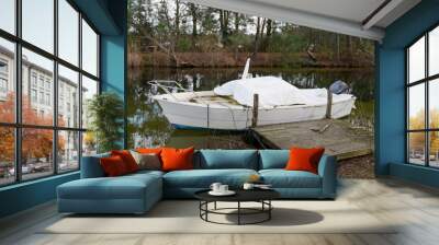 winter fibre glass cruise boat with white tarpaulin cover steering wheel and outboard dashboard seat in lake lacanau river Wall mural