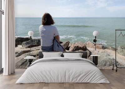 woman slim in holidays from behind looking at the sea Wall mural