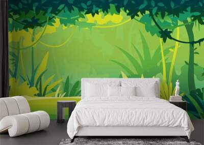 Small sunny lawn in wild jungle forest with trees, bushes and lianas, nature landscape with green jungle foliage and exotic plants growing on ground, tropical plants on sunny day Wall mural