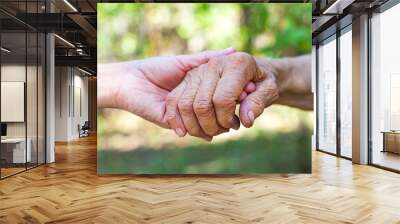 Shaking elderly hand Wall mural