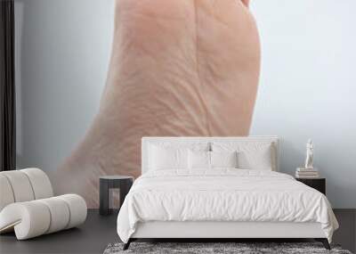 Caucasian male bare feet. Close up shot, isolated on white background, bottom view of bare sole Wall mural