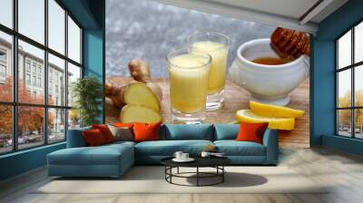 Ginger drink, juice or shot with fresh ingredients like ginger root, honey and lemon on wooden background. Wall mural