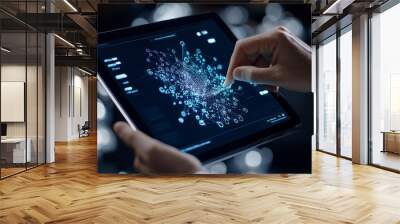 A person interacts with a digital network interface on a tablet, highlighting the interconnectedness of modern technology in a business environment. Wall mural